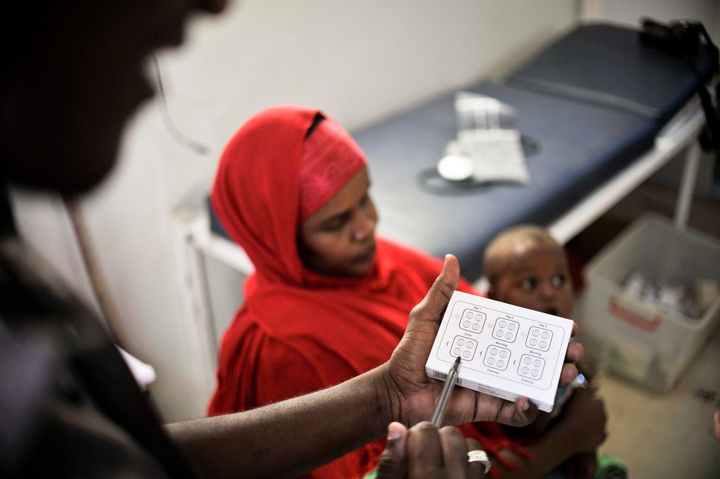A health worker with a mother and child