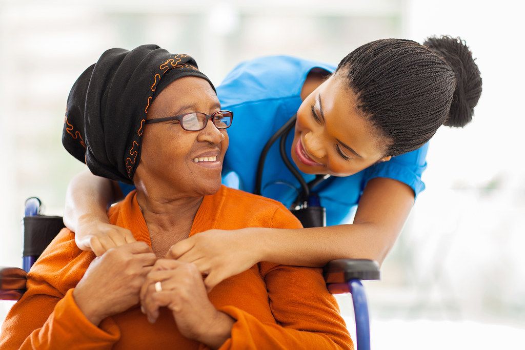 A nurse caring for an older woman